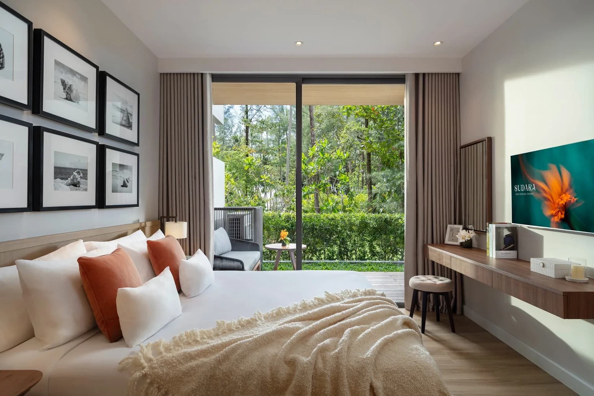 Main bedroom with garden-facing glazing in the Sudara show residence