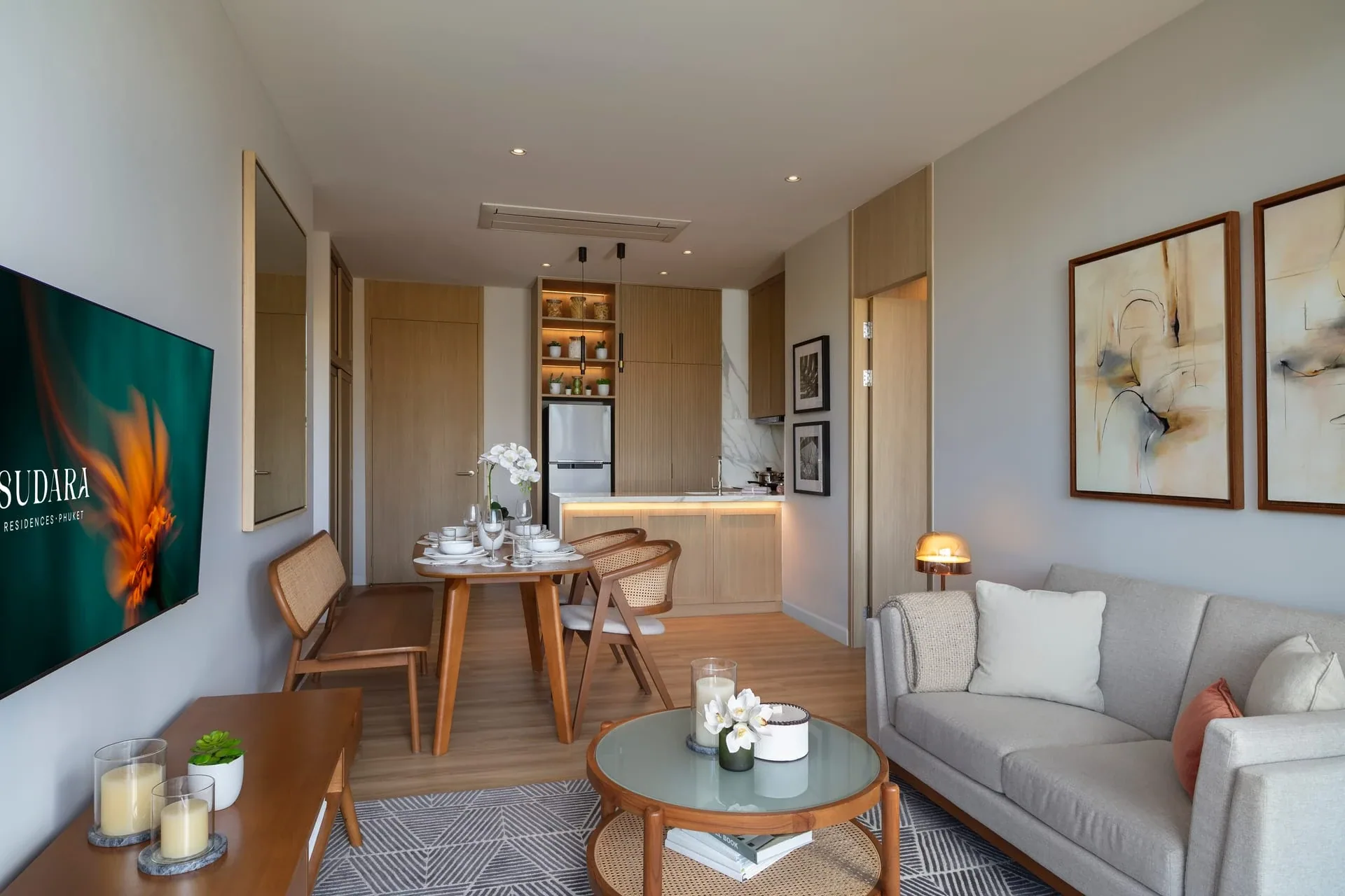 Living room with sofa and garden-facing glazing in the Sudara show residence